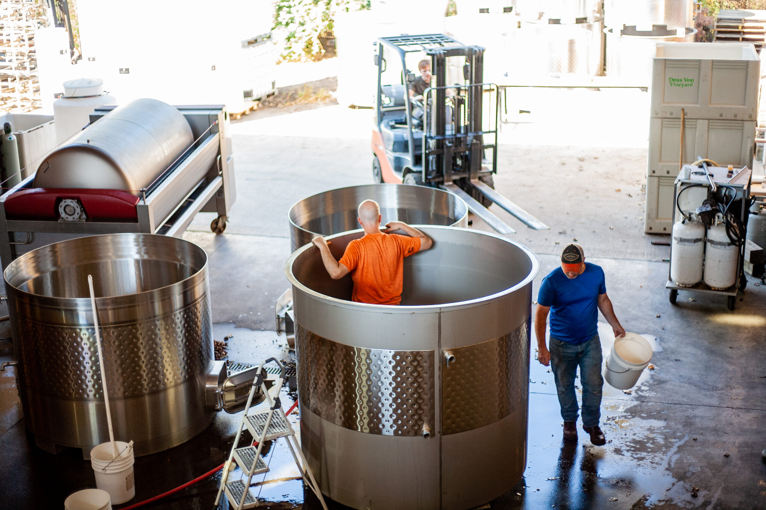 Cellarhand cleans stainless steel fermentation tank